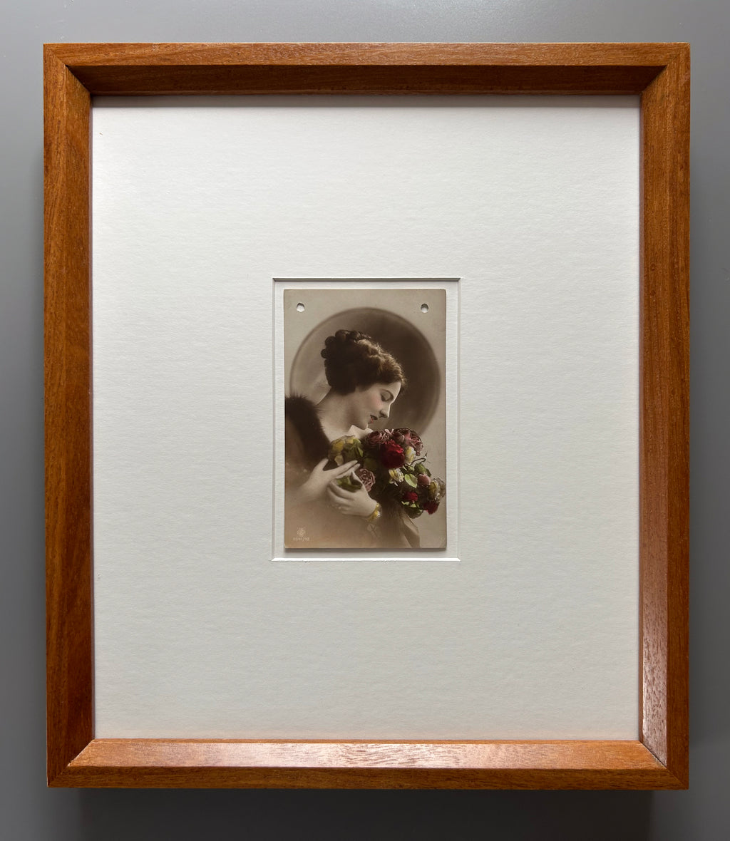 By any other name - Framed 1920s Hand-Colored Postcard with a Vintage soft portrait of a woman holding flowers Parisian Portrait in a handmade Merbau wood Frame