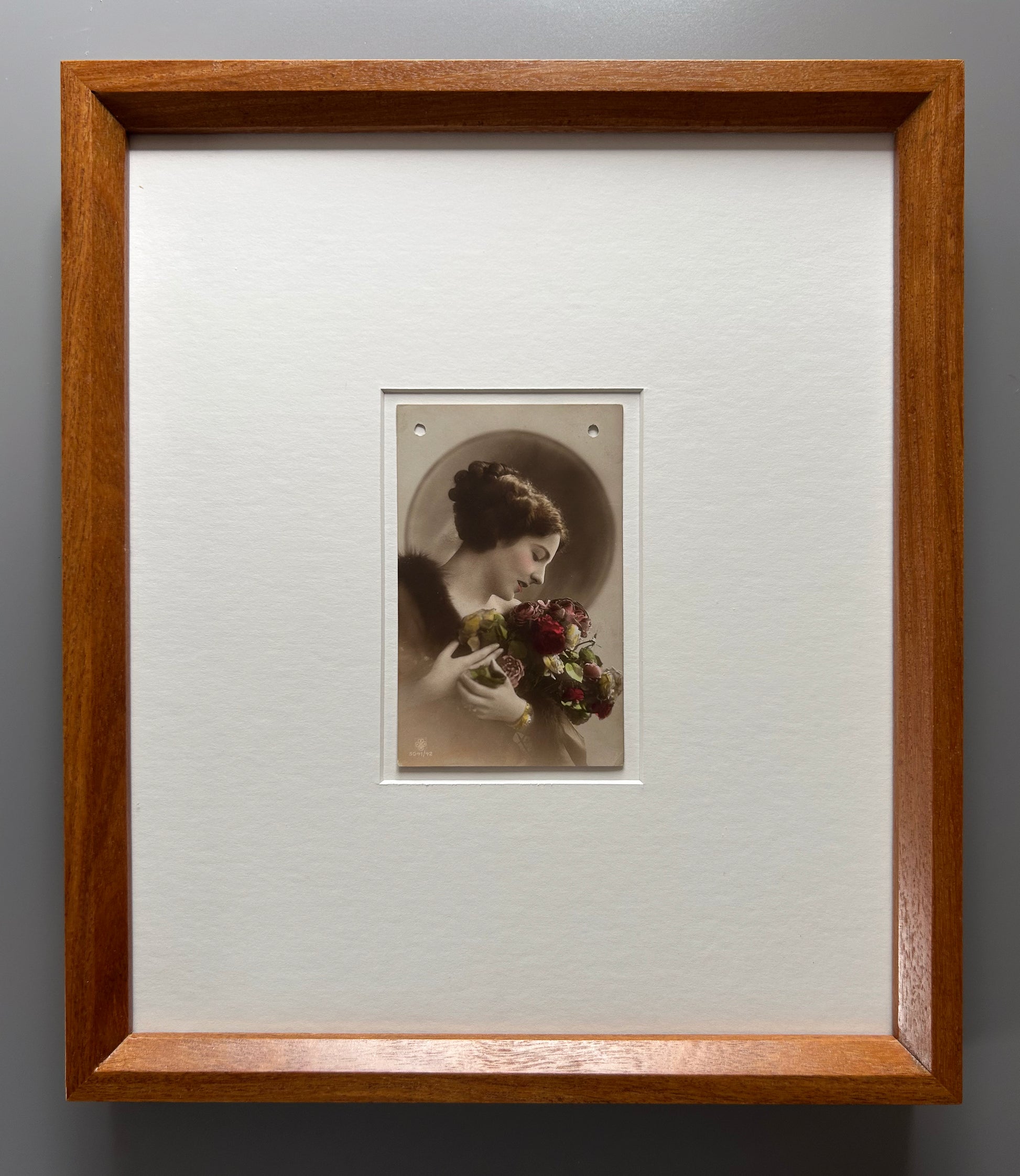 By any other name - Framed 1920s Hand-Colored Postcard with a Vintage soft portrait of a woman holding flowers Parisian Portrait in a handmade Merbau wood Frame
