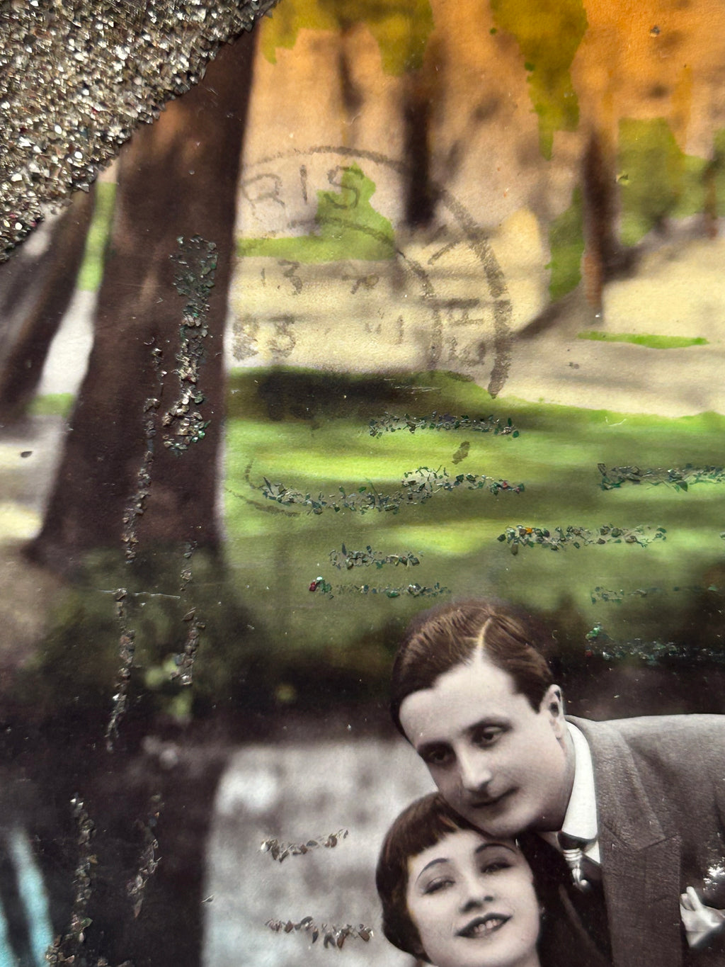 Starts with a great story - Framed 1920s Hand-Tinted and glittered Postcard featuring a tender couple’s embrace in a park – Vintage Romantic Art in Tigerwood Frame