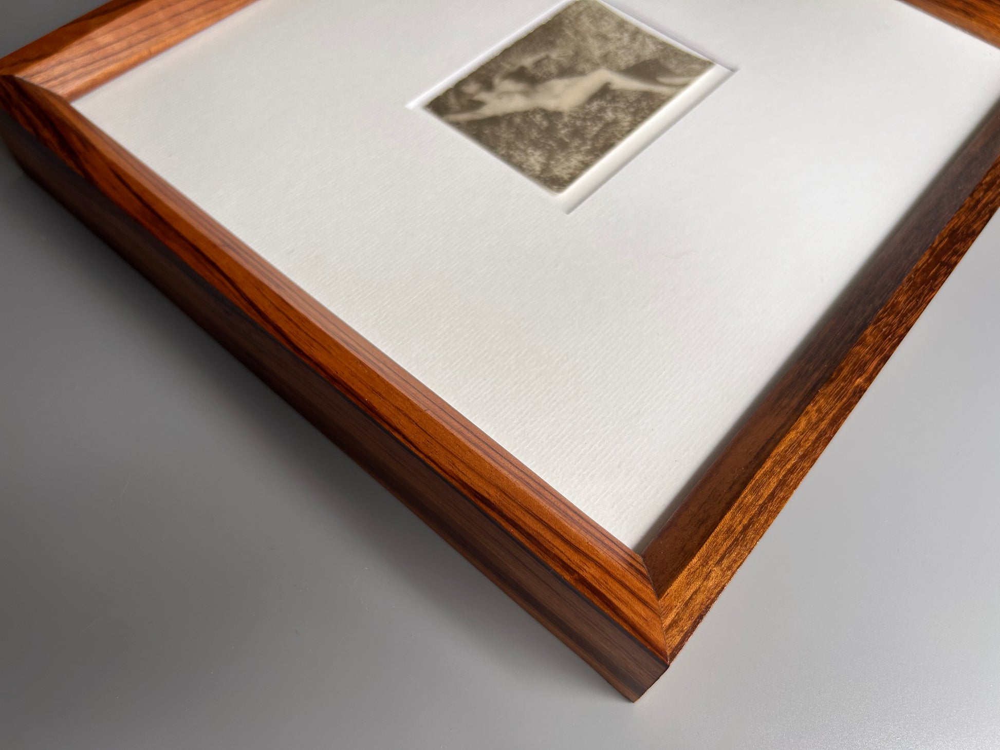Unarmed - Framed Vintage Nude Photo – 1950s Outdoor Reclining Figure in Jatoba Wood