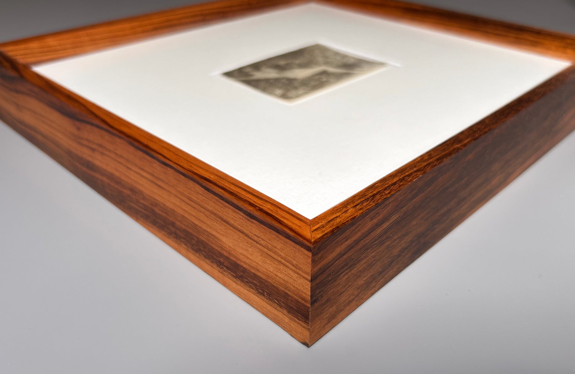 Unarmed - Framed Vintage Nude Photo – 1950s Outdoor Reclining Figure in Jatoba Wood