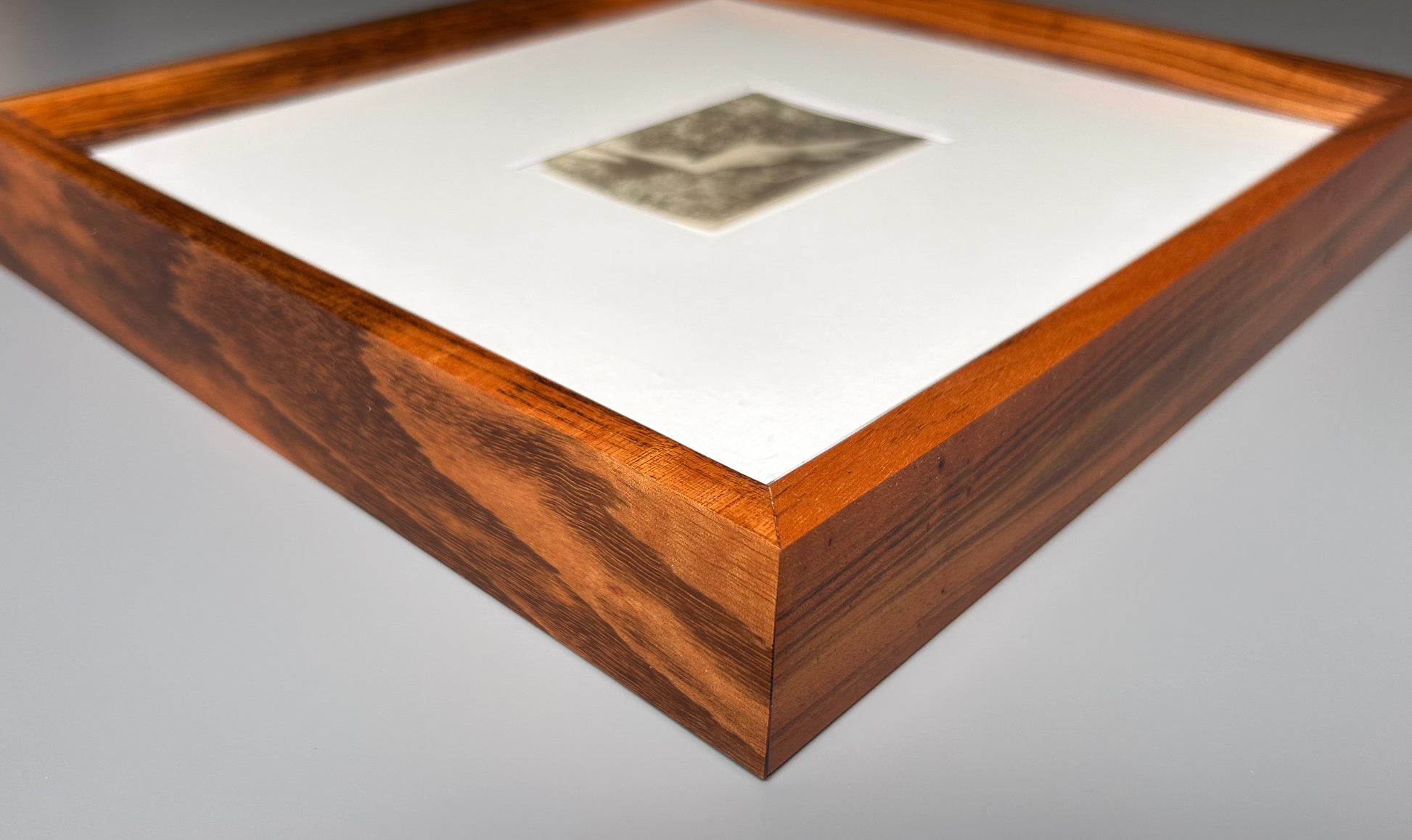 Unarmed - Framed Vintage Nude Photo – 1950s Outdoor Reclining Figure in Jatoba Wood