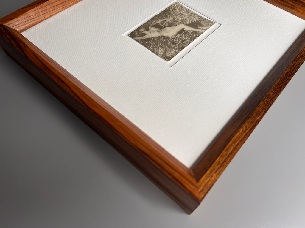 Unarmed - Framed Vintage Nude Photo – 1950s Outdoor Reclining Figure in Jatoba Wood