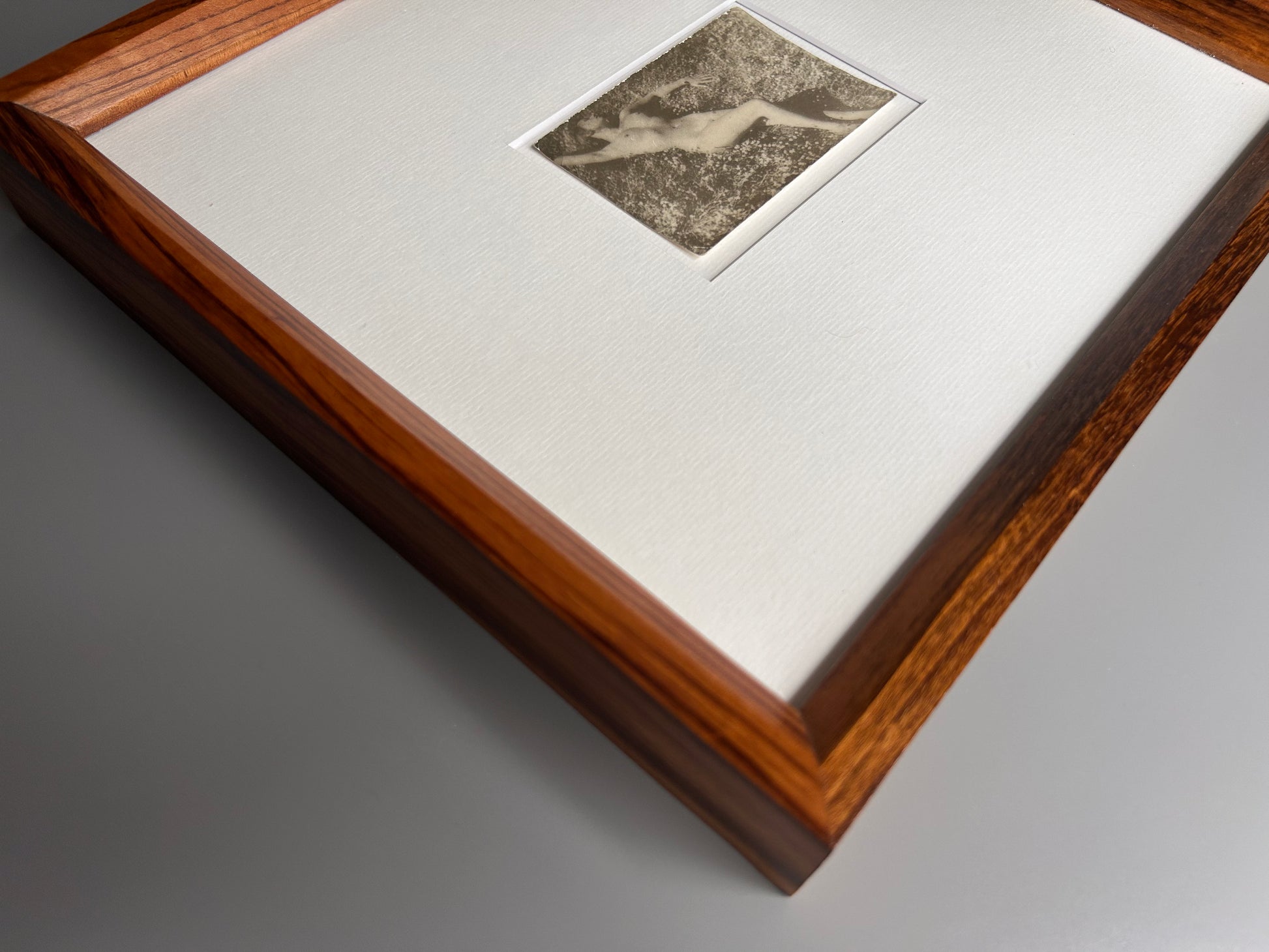 Unarmed - Framed Vintage Nude Photo – 1950s Outdoor Reclining Figure in Jatoba Wood