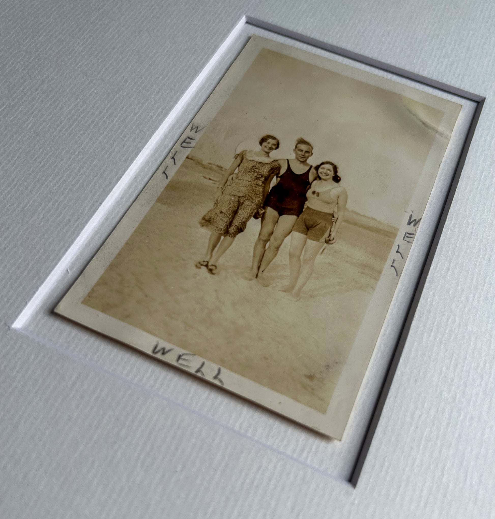 Well, well, well - handmade Framed Vintage Photo featuring a man standing with two women with handwritten Text – 1950s B&W Art Print: "Well Well Well"